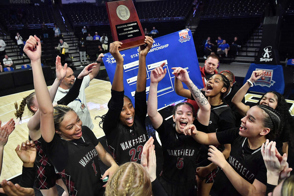 Wakefield’s Maddison McIntyre (22) celebrates with the East Regional Championship trophy and teammates after their 31-23 victory over Hoggard. The Wakefield Wolverines and the Hoggard Vikings met in the NCHSAA 4A East Regional Final in Winston-Salem, N.C. on March 12, 2025.
