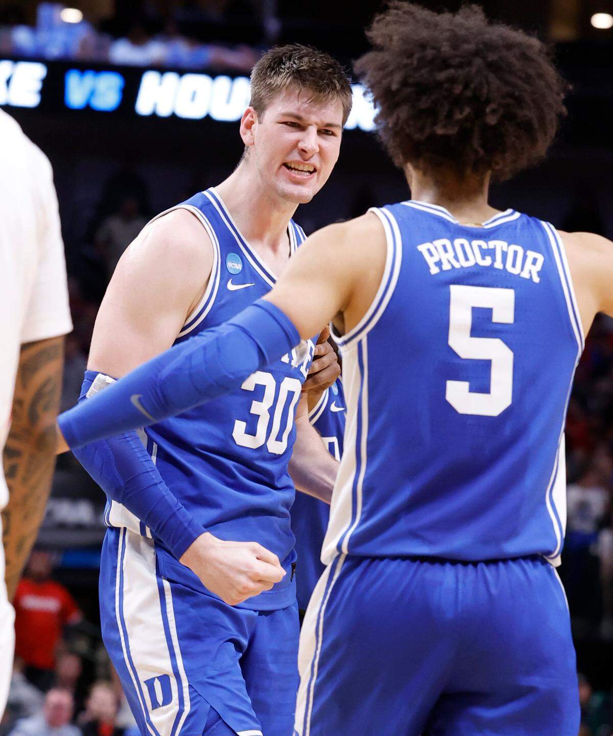 Duke’s Kyle Filipowski (30) celebrates with Tyrese Proctor (5) after Filipowski made the basket while being fouled during the second half of Duke’s 54-51 victory over Houston in their NCAA Tournament Sweet 16 game at the American Airlines Center in Dallas, Texas, Friday, March 29, 2024.