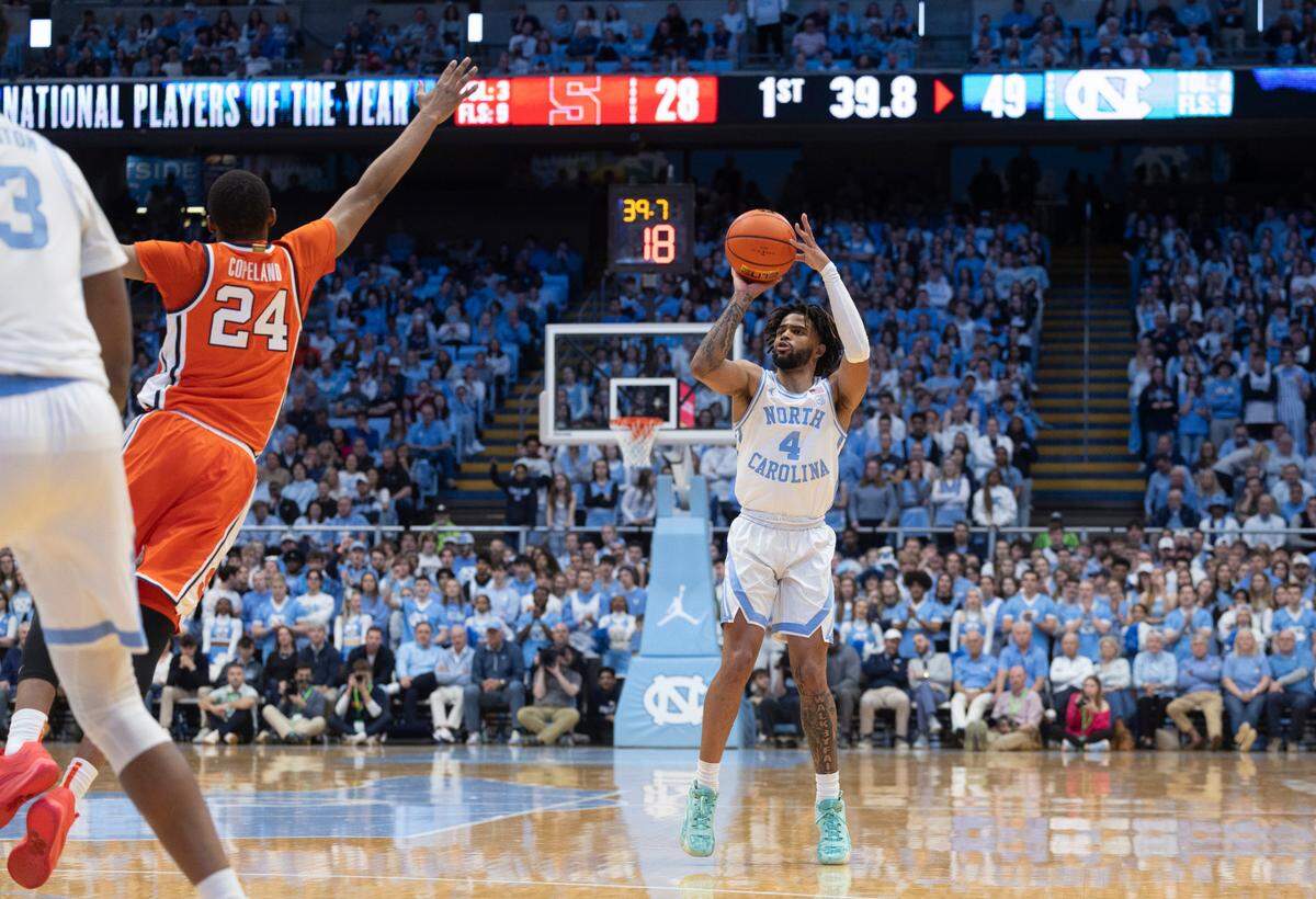 North Carolina’s R.J. Davis (4) launches a three-point shot over Syracuse’s Quadir Copeland (24) in the first half on Saturday, January 13, 204 at the Smith Center in Chapel Hill, N.C.