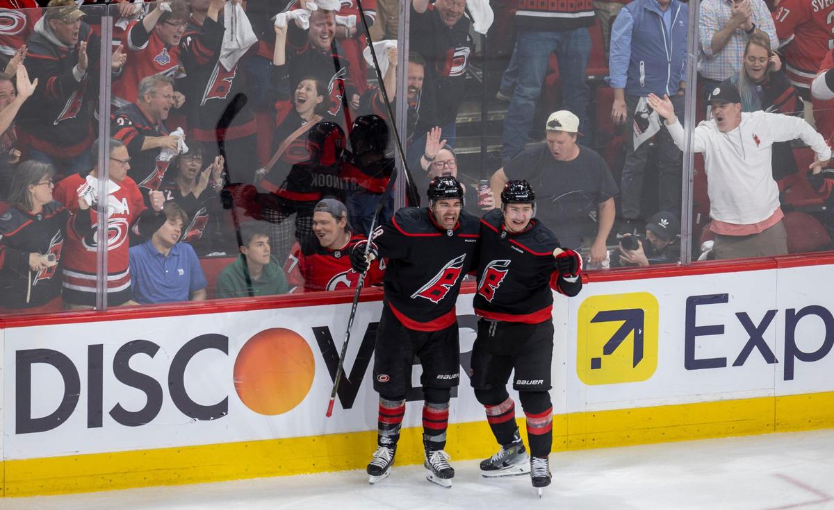 Carolina Hurricanes defenseman Dmitry Orlov (7) embraces Jordan Martinook (48), after MartinookÕs goal to take a 2-1 lead over the New Jersey Devils during game two of their Stanley Cup playoff series on Tuesday, April 22, 2025 at Lenovo Center in Raleigh, N.C.
