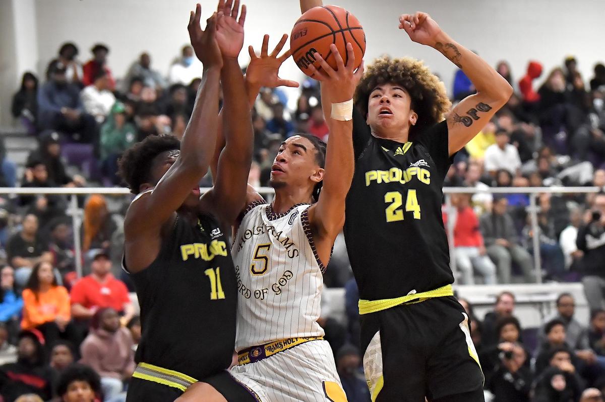 Word of God’s Freddie Dilione (5) attempts the lay-up against Profic Prep’s Zion Sensley (4) and N’famaara Debo (11). The Word of God Holy Rams and Prolific Prep (CA) met in the John Wall Holiday Invitational in Raleigh, N.C. on December 30,2022 .