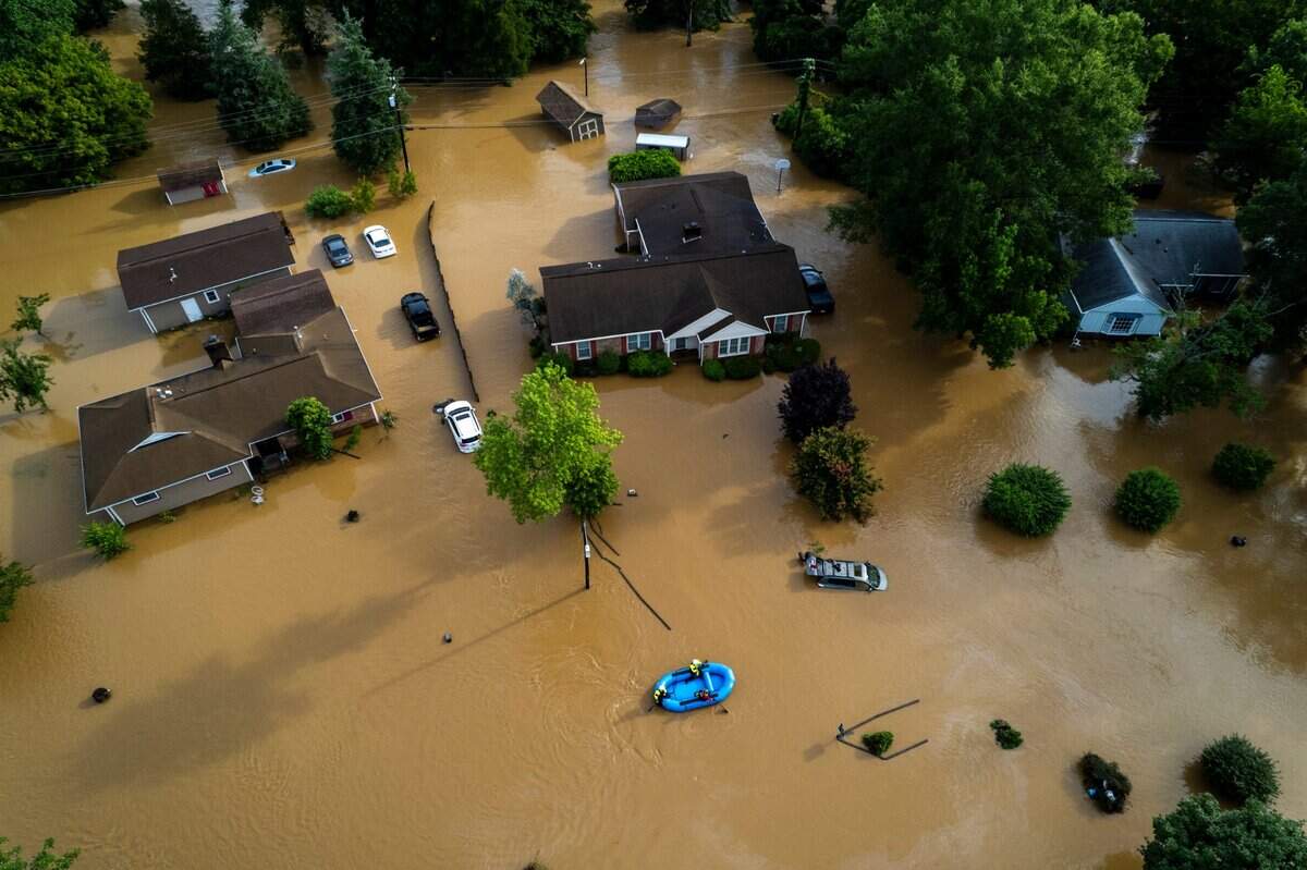 A water rescue unit paddles a raft in the Old Farm neighborhood along the Eno River in Durham on Monday morning, July 7, 2025, after Tropical Storm Chantal caused flash flooding.