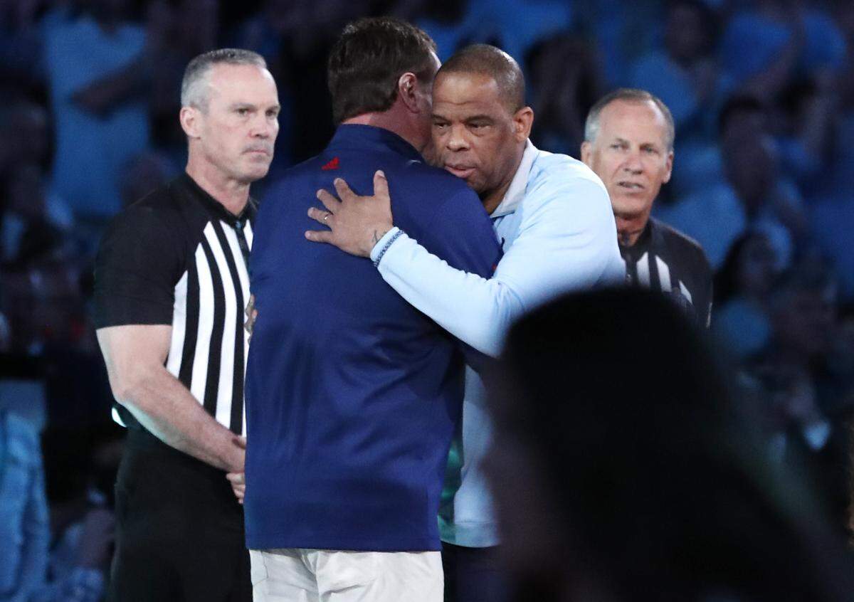 North Carolina head coach Hubert Davis and Kansas head coach Bill Self greet each other before UNC’s game against Kansas in the NCAA Men’s National Championship at the Caesars Superdome in New Orleans, La., Monday, April 4, 2022.