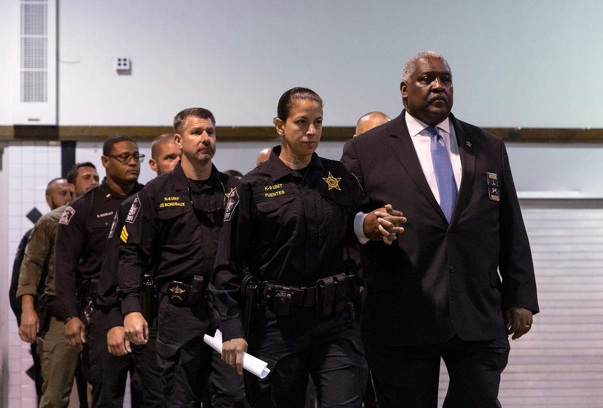 Master Deputy Maria Fuentes walks alongside Wake County Sheriff Willie Rowe at the start of a memorial service for K9 Santos, a Wake County sheriff’s dog, at the Kerr Scott Building on Wednesday, June 14, 2023, in Raleigh, N.C. K9 Santos, a German shepherd, was accidentally shot and killed by a Knightdale police officer after a traffic stop in May.
