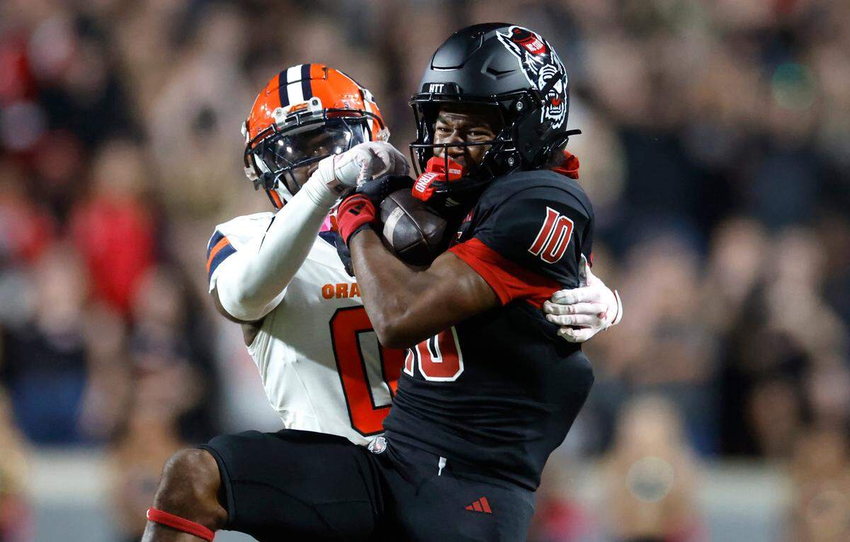 N.C. State wide receiver KC Concepcion (10) pulls in a long reception while defended by Syracuse defensive back Duce Chestnut (0) during the first half of N.C. State’s game against Syracuse at Carter-Finley Stadium in Raleigh, N.C., Saturday, Oct. 12, 2024.