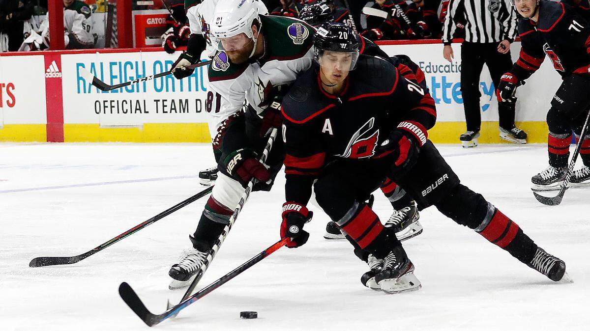 Carolina Hurricanes’ Sebastian Aho (20) and Arizona Coyotes’ Phil Kessel (81) tussle during the third period of an NHL hockey game in Raleigh, N.C., Sunday, Oct. 31, 2021. (AP Photo/Karl B DeBlaker)