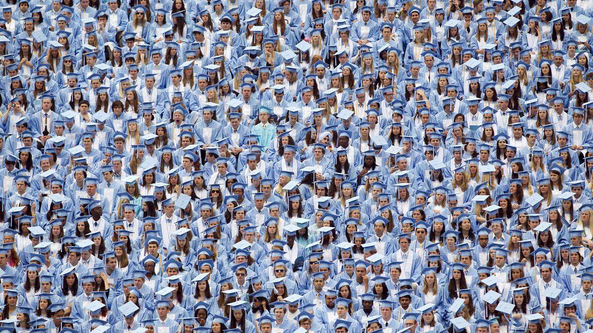 Graduates of the University of North Carolina fill the stands of Kenan Stadium during a commencement.
