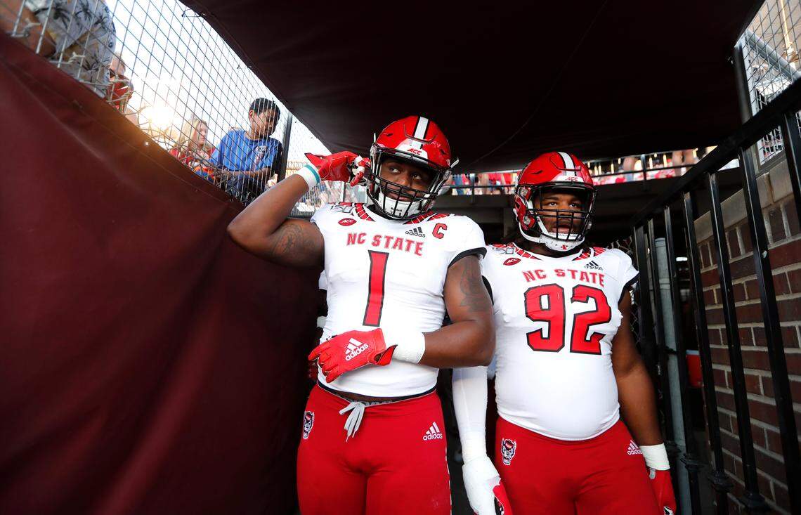 N.C. State’s James Smith-Williams (1) and Larrell Murchison (92) head out onto the field to wam up before N.C. State’s game against Florida State at Doak Campbell Stadium in Tallahassee, Fla., Saturday, Sept. 28, 2019.
