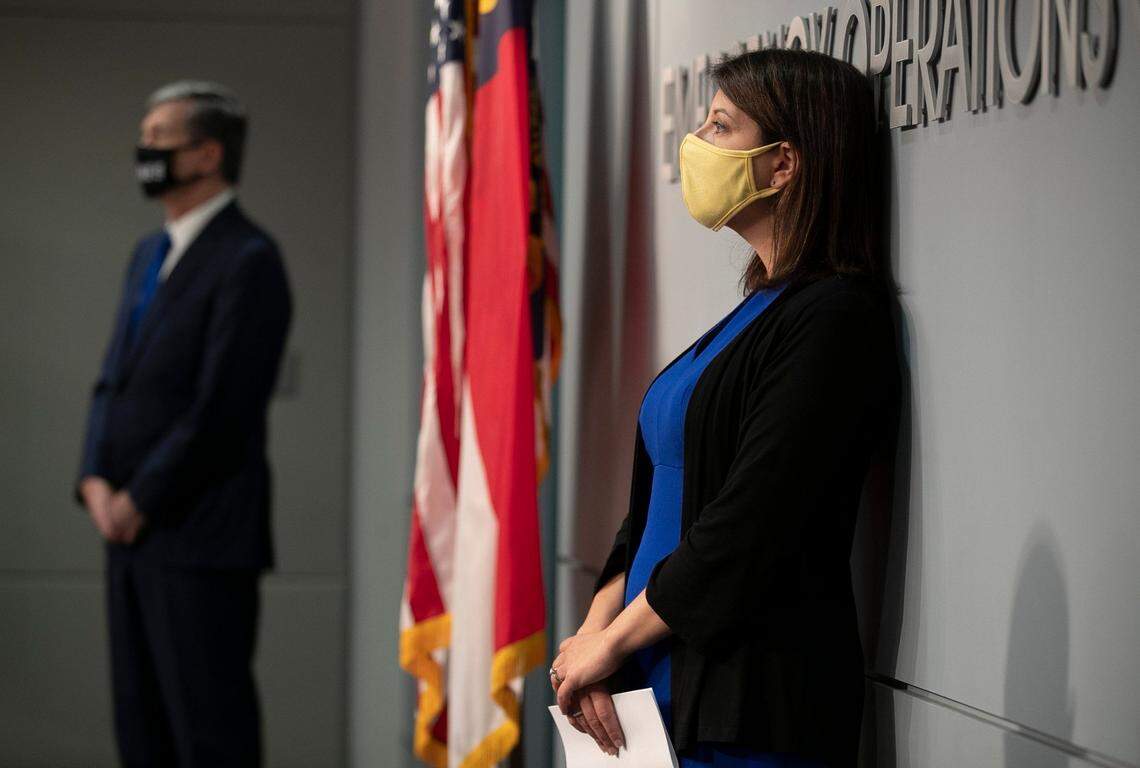 In this file photo, North Carolina Gov. Roy Cooper and Dr. Mandy Cohen, then-Secretary of the North Carolina Department of Health and Human Services, listen to Sec. Erik Hooks, NC Department of Public Safety, during a press briefing on the COVID-19 virus at the Emergency Operations Center on Wednesday, August 19, 2020 in Raleigh, N.C.