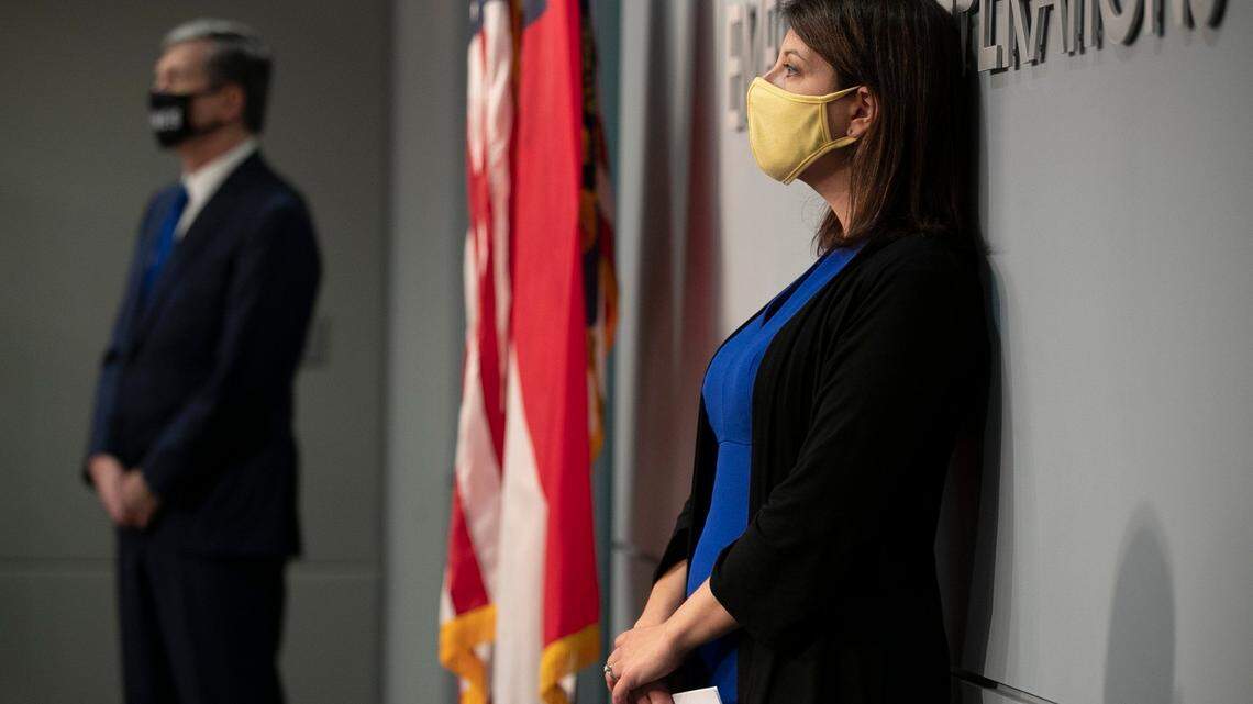 North Carolina Governor Roy Cooper and Dr. Mandy Cohen, Secretary of the North Carolina Department of Health and Human Services, listen to Sec. Erik Hooks, NC Department of Public Safety, during a press briefing on the COVID-19 virus at the Emergency Operations Center on Wednesday, August 19, 2020 in Raleigh, N.C.