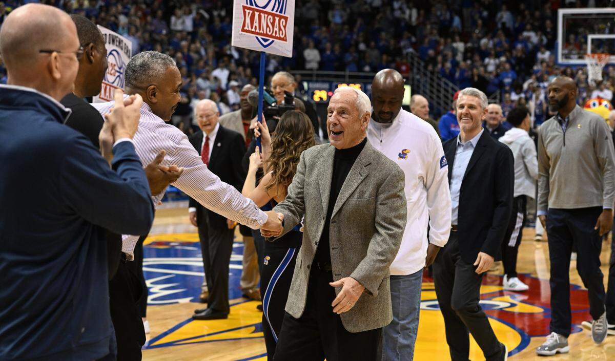 Former Kansas coach Roy Williams, is greeted by former players and staff during halftime ceremonies at Allen Fieldhouse. Kansas was celebrating 125 years in college basketball.