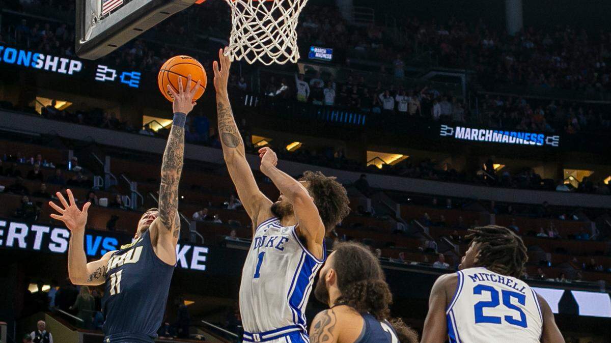 Duke’s Dereck Lively II (1) blocks a shot by Oral Roberts’ Carlos Jurgens (11) in the first half during the first round of the NCAA Tournament on Thursday, March 16, 2023 at the Amway Center in Orlando, Fla. Lively II had six blocks in the Blue Devils’ victory.