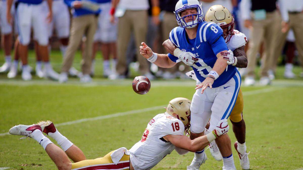 Boston College defensive back Deon Jones (5) forces Duke Blue quarterback Chase Brice (8) to fumble as Boston College defensive back Mike Palmer helps to make the tackle during the second half of an NCAA college football game, Saturday, Sept. 19, 2020, in Durham, N.C. (Nell Redmond/Pool Photo via AP)
