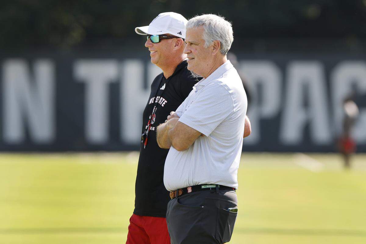 N.C. State head coach Dave Doeren talks with athletic director Boo Corrigan during the Wolfpack’s first fall practice Wednesday, July 30, 2025.