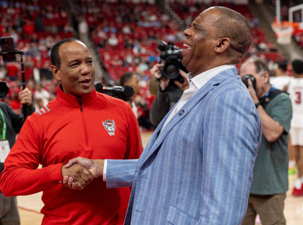North Carolina coach Hubert Davis shakes hand with N.C. State coach Kevin Keatts prior to their game on Saturday, January 11, 2025 at Lenovo Center in Raleigh, N.C.