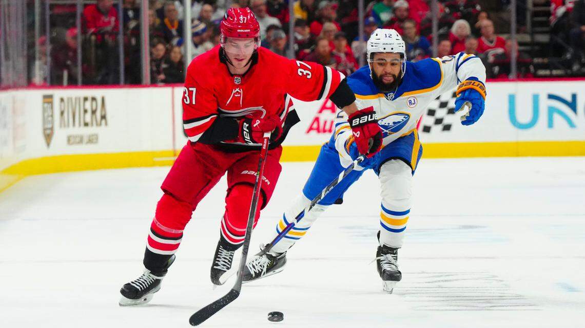 Carolina Hurricanes right wing Andrei Svechnikov (37) skates with the puck past Buffalo Sabres left wing Jordan Greenway (12) during the first period at PNC Arena.