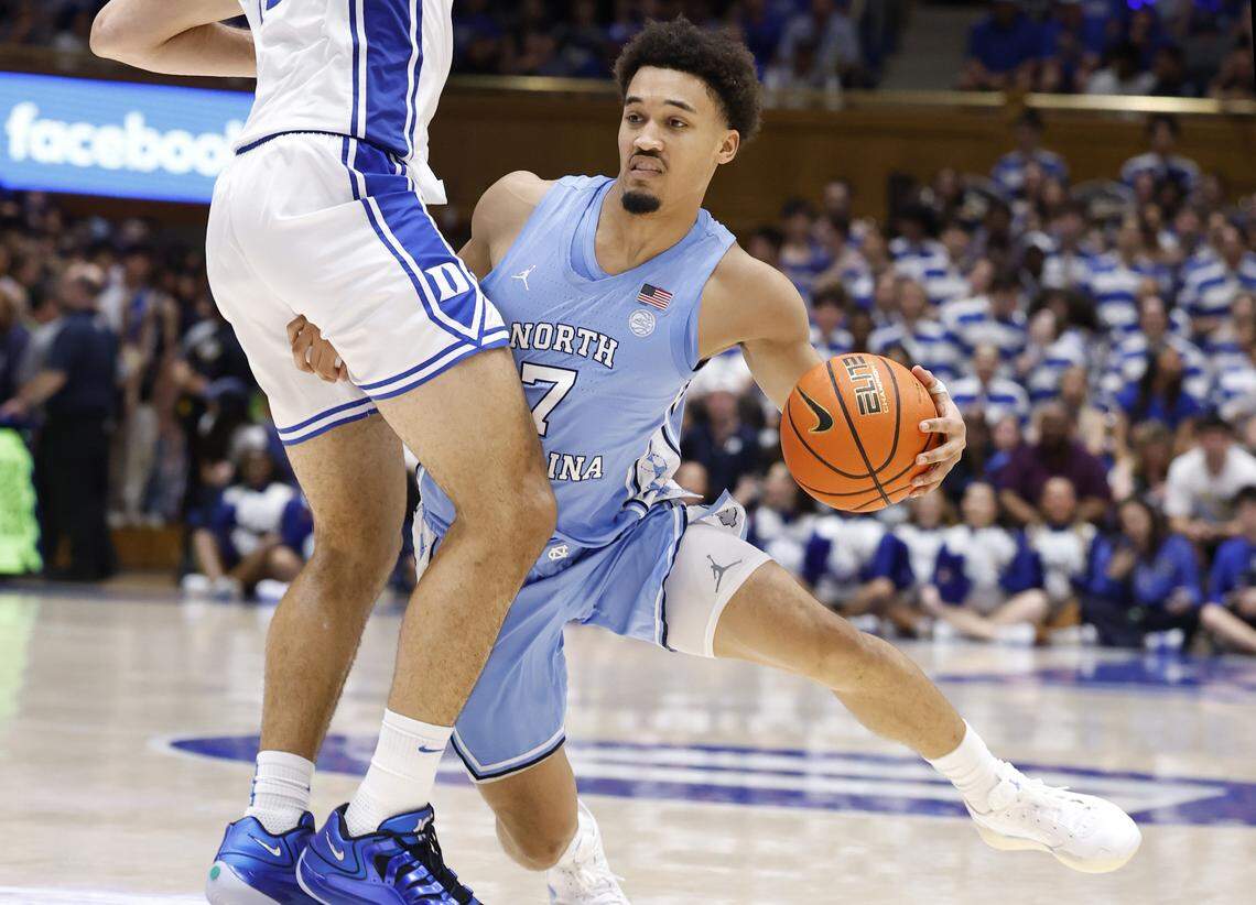 North Carolina's Seth Trimble (7) drives around Duke’s Cameron Boozer (12) during the first half of Duke’s game against UNC at Cameron Indoor Stadium in Durham, N.C., Saturday, March 7, 2026.