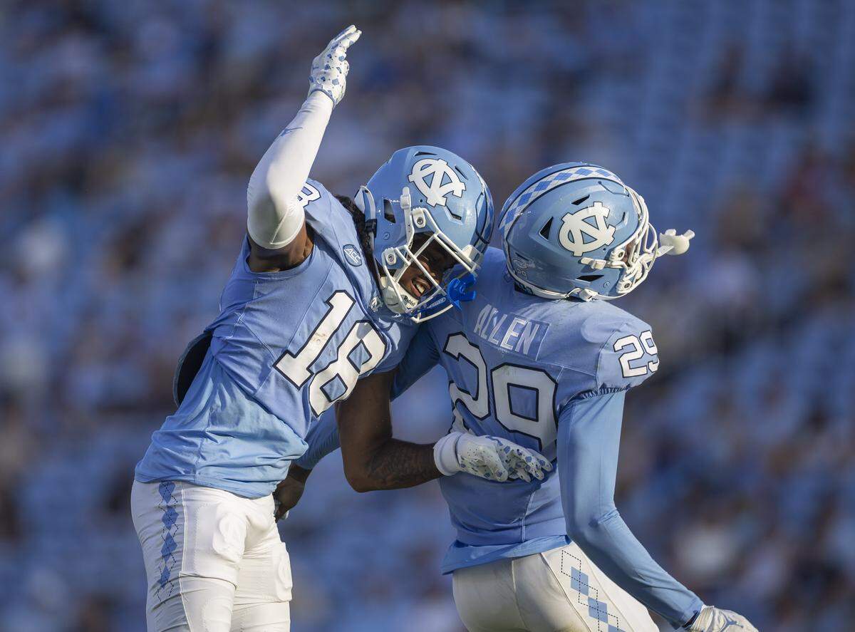North Carolina defense back Jaiden Patterson (18) celebrates with teammate Marcus Allen (29) after intercepting a pass by Richmond quarterback Ashten Snelsire in the fourth quarter on Saturday, September 13, 2025 at Kenan Stadium in Chapel Hill, N.C.