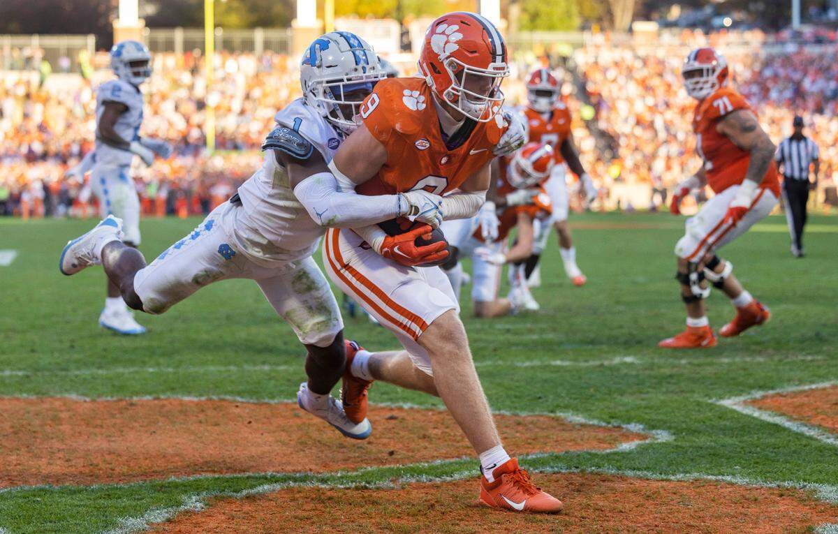 North Carolina Antavious Lane (1) defends Clemson’s Jake Briningstool (9) as he scores on a three-yard pass from quarterback Cade Klubnik to tie North Carolina 7-7 in the second quarter on Saturday, November 18, 2023 at Memorial Stadium in Clemson, S.C.