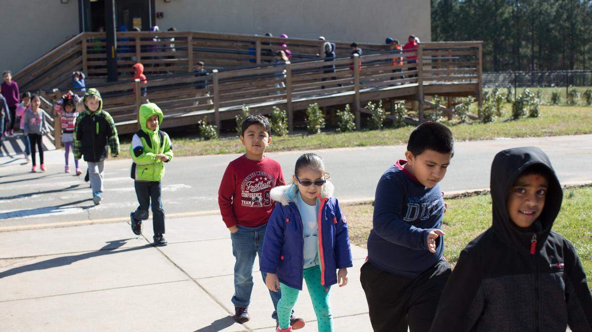 In this 2016 photo, students exit their modular classroom unit at Cedar Fork Elementary School in Morrisville. Wake County school administrators recommend leaving an enrollment cap on Cedar Fork.