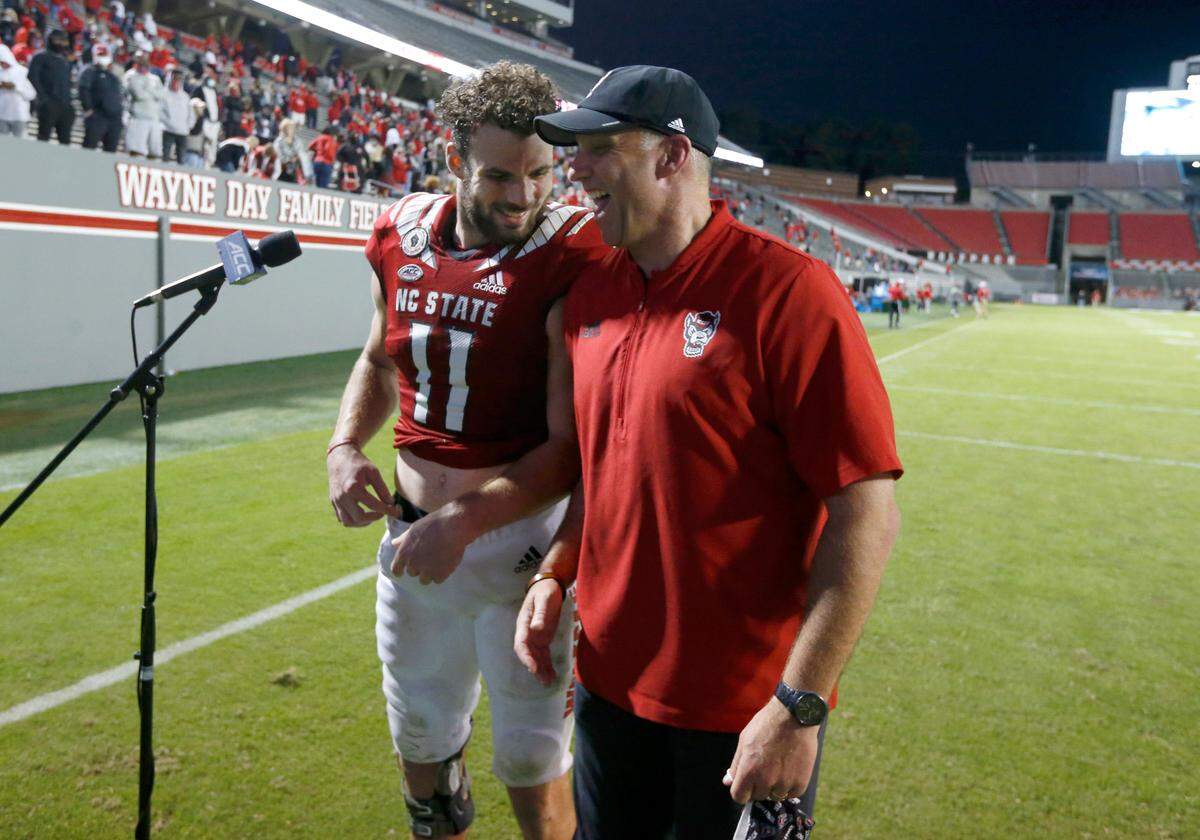 N.C. State head coach Dave Doeren laughs with Payton Wilson (11) after the Wolfpack’s victory over Duke in October 2020.