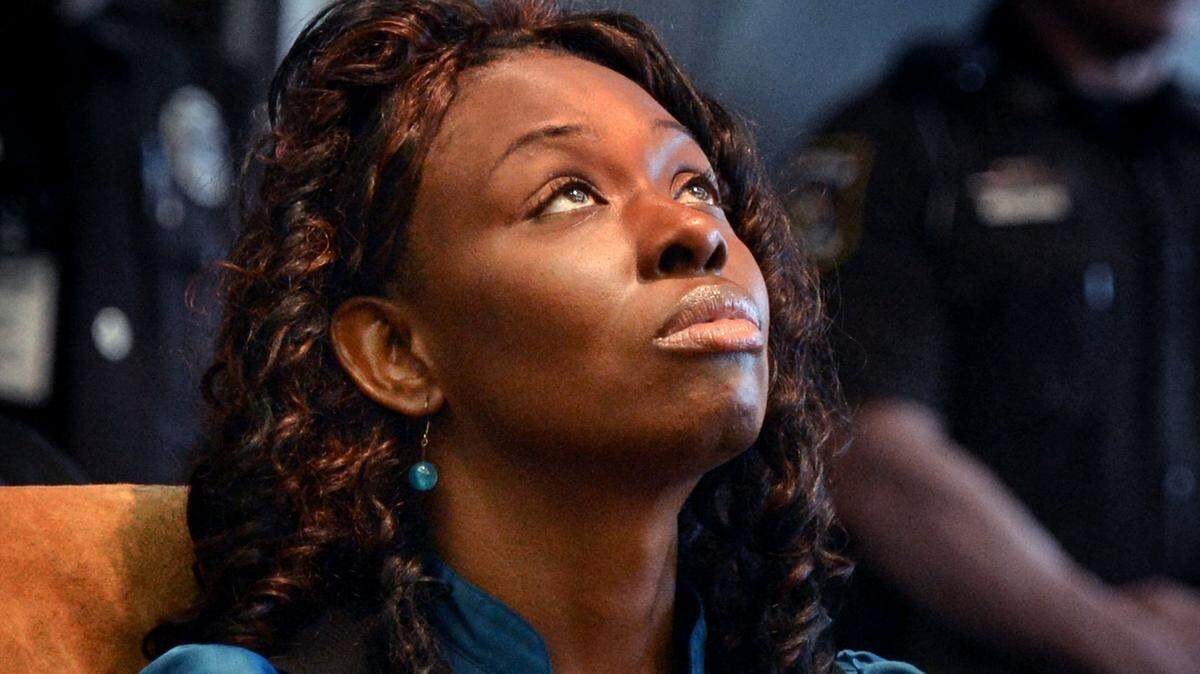 Crystal Mangum looks at the ceiling of the courtroom as her verdict is read by Durham Clerk of the Court Keshia Perry on Nov. 22, 2013. She was found guilty of second-degree murder in the stabbing death of her boyfriend, Reginald Daye, in 2011. Superior Court Judge Paul Ridgeway sentenced Mangum to a minimum of 14 years and two months to a maximum of 18 years in prison.
