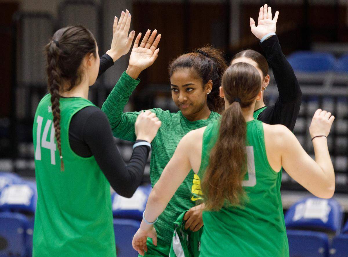 Oregon’s Deja Kelly high-fives teammates during practice at Cameron Indoor Stadium on Thursday, March 20, 2025, in Durham, N.C. Kelly transferred to Oregon this season after playing four seasons at North Carolina. The Ducks will face Vanderbilt in the first round of the NCAA Tournament on Friday.