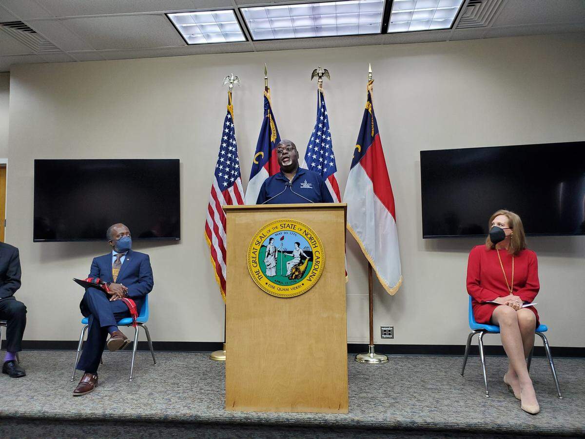 Winston-Salem Black Chamber of Commerce President Calvin Patterson, center, talks about the Business Recovery Grant Program at a press conference Thursday, Jan. 27, 2022 at the Department of Administration building in downtown Raleigh. On the left is Department of Revenue Secretary Ronald Penny; on the left is North Carolina Restaurant and Lodging Association President and CEO Lynn Minges.