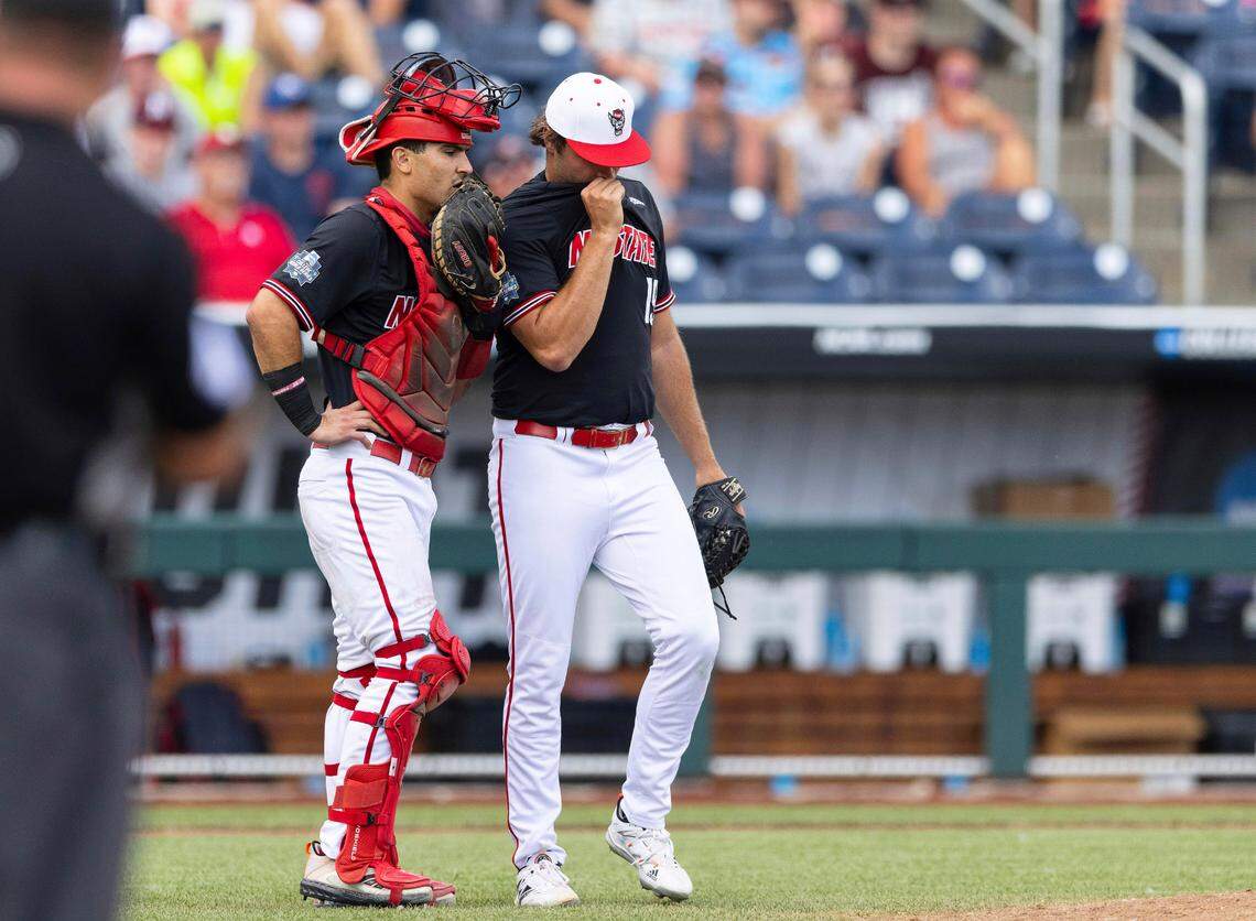 North Carolina State catcher Luca Tresh, left, talks with pitcher Dalton Feeney in the sixth inning during a baseball game against Vanderbilt in the College World Series, Friday, June 25, 2021, at TD Ameritrade Park in Omaha, Neb.