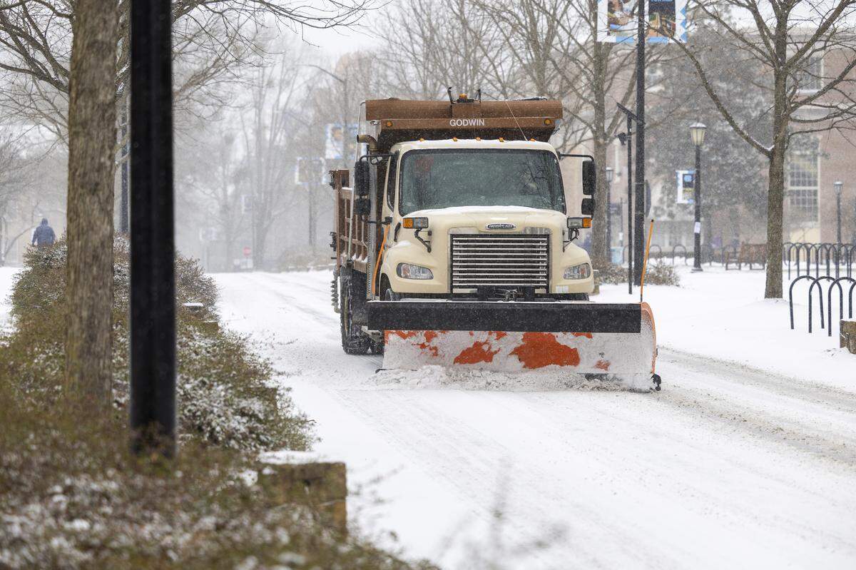 A snowplow clears snow on East Cameron Avenue in Chapel Hill on Saturday afternoon, Jan. 31, 2026, as a winter storm brings snow and freezing temperatures to the region.