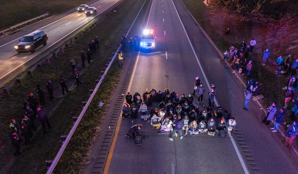 Protesters block the northbound lanes of the Durham Freeway at the South Magnum Street bridge for hours Thursday evening, Nov. 2, 2023 while demanding a ceasefire in the Israel-Gaza War as police warned of arrests.