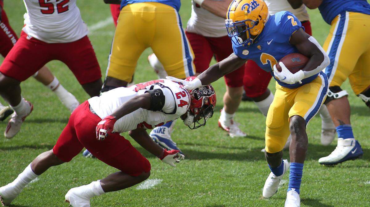 PITTSBURGH, PA - OCTOBER 03: Israel Abanikanda (2) of the Pittsburgh Panthers stiff arms Malik Dunlap (24) of the North Carolina State Wolfpack during the first half at Hienz Field in Pittsburgh, PA on October 3, 2020. (Photo by Michael Longo/Icon Sportswire)