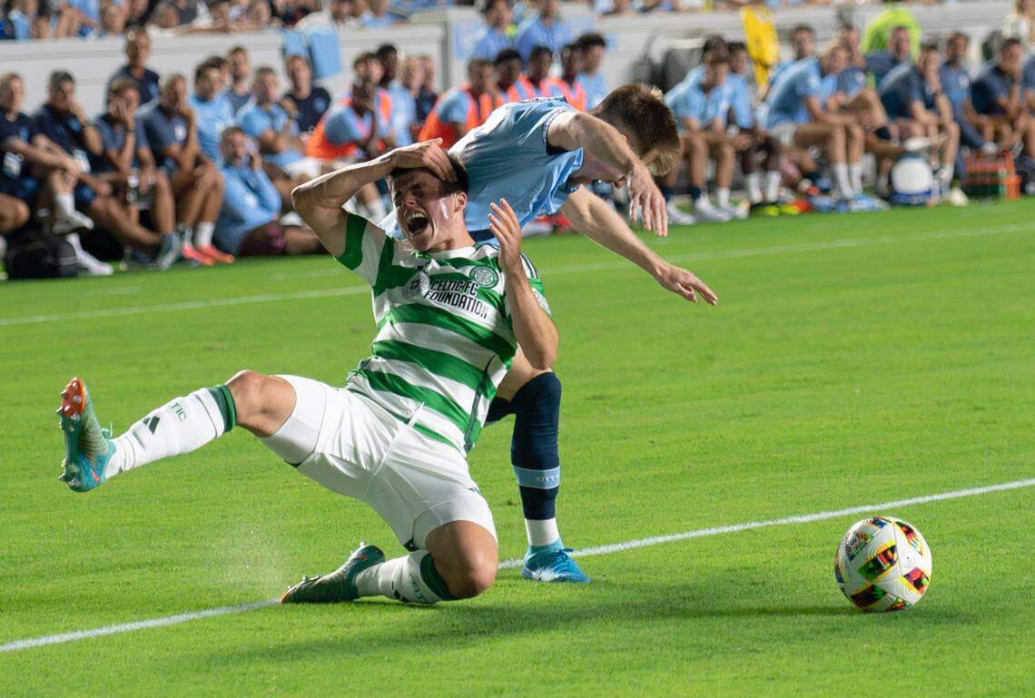 Celtic FC defender Gustaf Lagerbielke (4) falls to the ground as he tries to win the ball from Manchester City midfielder Ben Knight (96) during the Celtic FC vs Manchester City at Kenan Stadium in Chapel Hill on Tuesday, July 23, 2024. Celtic FC won 4-3.