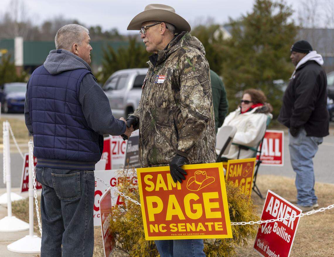 William Rierson shakes hands with Rockingham County Sheriff Sam Page, a candidate for NC Senate, at the Madison-Mayodan Public Library polling site on Tuesday, February 24, 2026 in Madison, N.C. Page is challenging NC Senator Phil Berger in the primary.