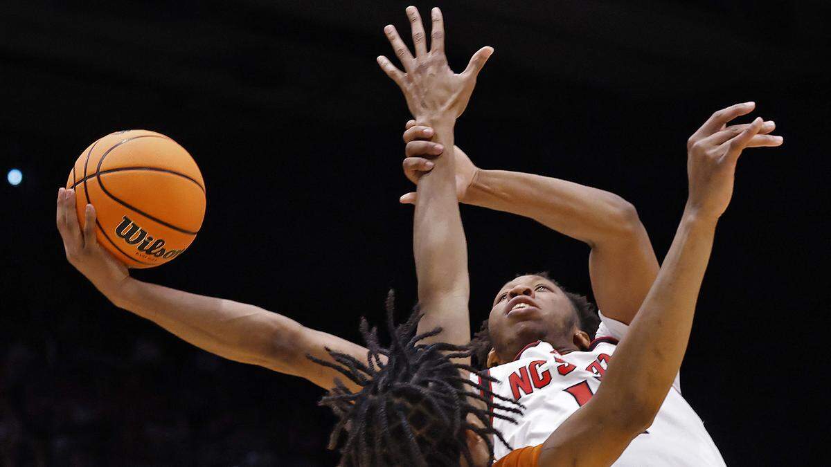 N.C. State’s Quadir Copeland drives to the basket past Texas’ Simeon Wilcher during the first half of the Wolfpack’s game during the NCAA First Four on Tuesday, March 17, 2026, at the University of Dayton Arena in Dayton, Ohio. 