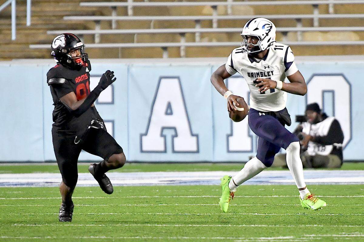 Grimsley quarterback Faizon Brandon (11) scrambles for yards ahead of Rolesville’s Jayden Fry (91) during the second half. The Rolesville Rams and the Greensboro Grimsley Whirlies met in the NCHSAA 4A football Championship Game in Chapel Hill, N.C. on December 20, 2024.