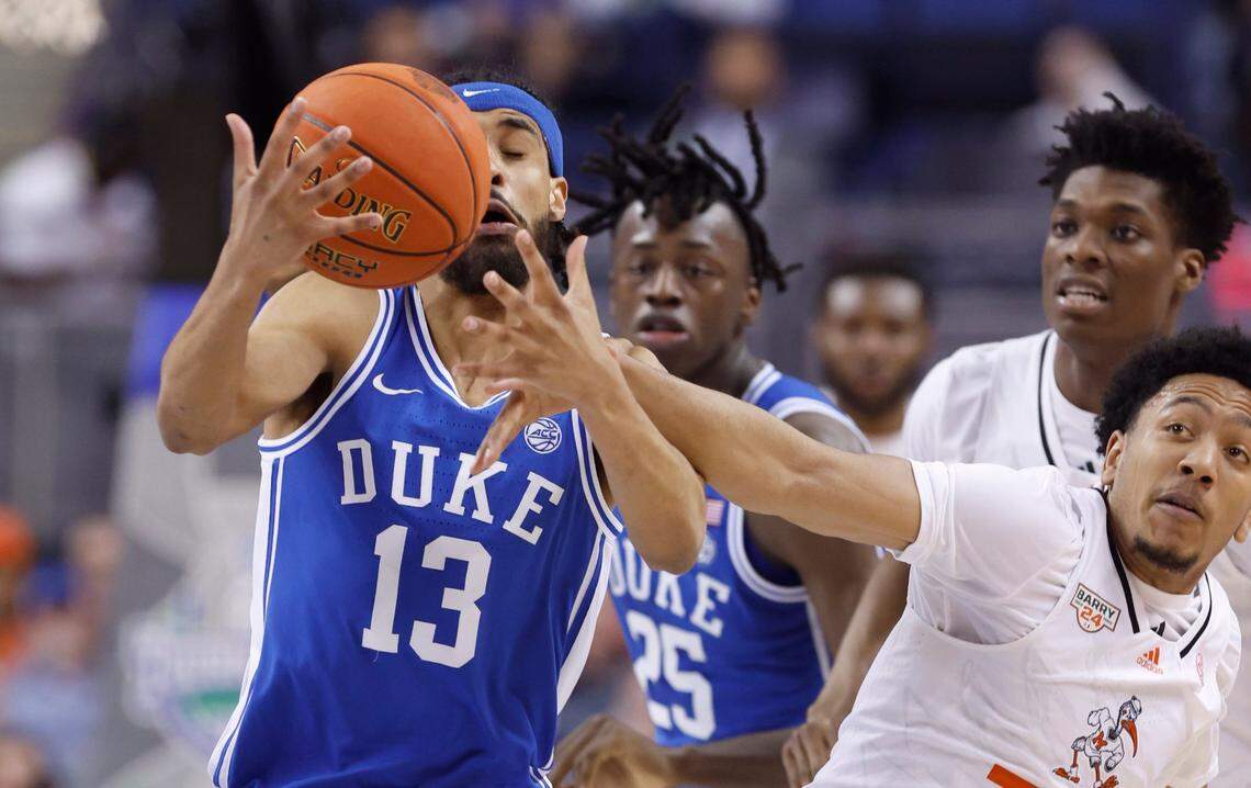 Duke’s Jacob Grandison gets to the ball before Miami’s Nijel Pack during the first half of Duke’s game against Miami in the semifinals of the ACC Men’s Basketball Tournament in Greensboro, N.C., Friday, March 10, 2023.