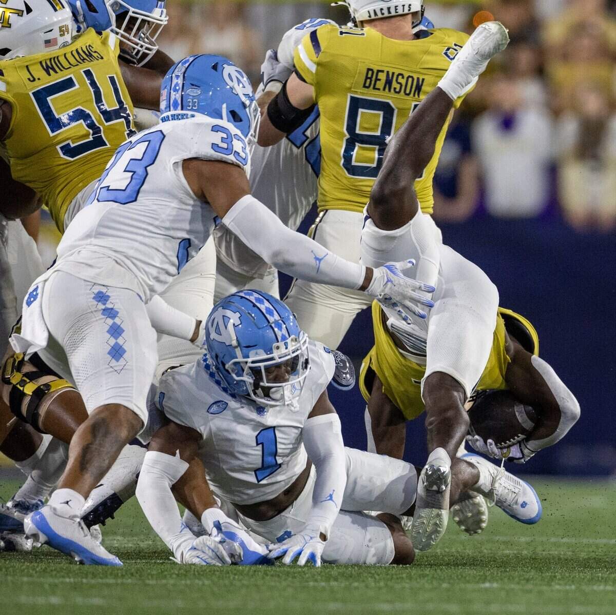 Georgia Tech’s Jamal Haynes (11) is stopped on fourth down by North Carolina’s Antavious Lane (1) in the first quarter on Saturday, October 28, 2023 at Bobby Dodd Stadium in Atlanta, Georgia.