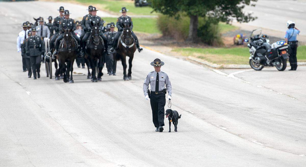 Wake County Deputy A. Staton and Sasha, K-9 partner of slain Wake County Sheriff’s Deputy Ned Byrd, lead the N.C. State Highway Patrol’s Caisson Unit before Byrd’s funeral in 2022.