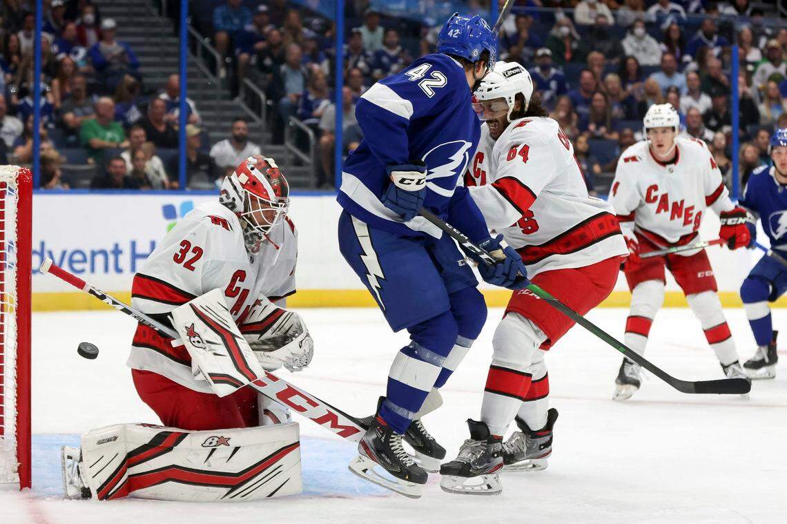 Carolina Hurricanes goaltender Antti Raanta (32) makes a save behind Tampa Bay Lightning’s Otto Somppi as he is defended by Jalen Chatfield (64) during the second period of a preseason NHL hockey game Friday, Oct. 1, 2021, in Tampa, Fla. (AP Photo/Mike Carlson)