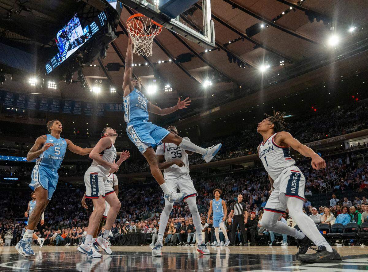 North Carolina’s Harrison Ingram (55) goes to the basket for two of his 20 points against Connecticut’s Samson Johnson (35) during the second half in the Jimmy V Classic on Tuesday, December 5, 2023 at Madison Square Garden in New York, NY.