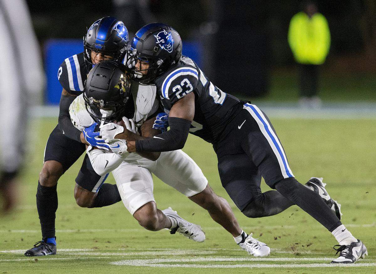 Duke’s Chandler Rivers and Terry Moore tackle Wake Forest’s Ke’Shawn Williams during the first half of the Blue Devils’ 24-21 win on Thursday, Nov. 2, 2023, at Wallace Wade Stadium in Durham, N.C.