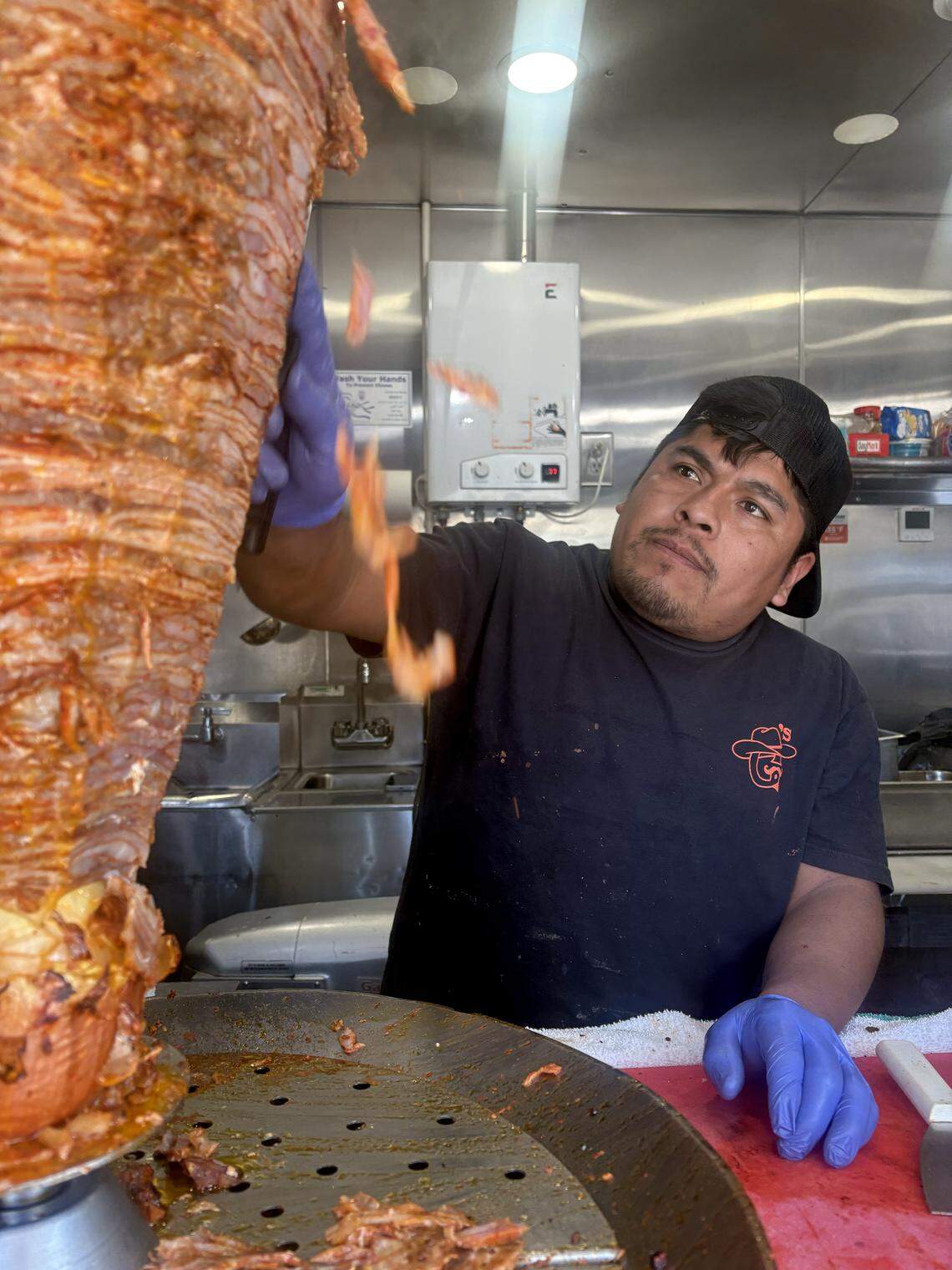 Meat is shaved from a trompo at G’s Tacos on Six Forks Road in Raleigh.