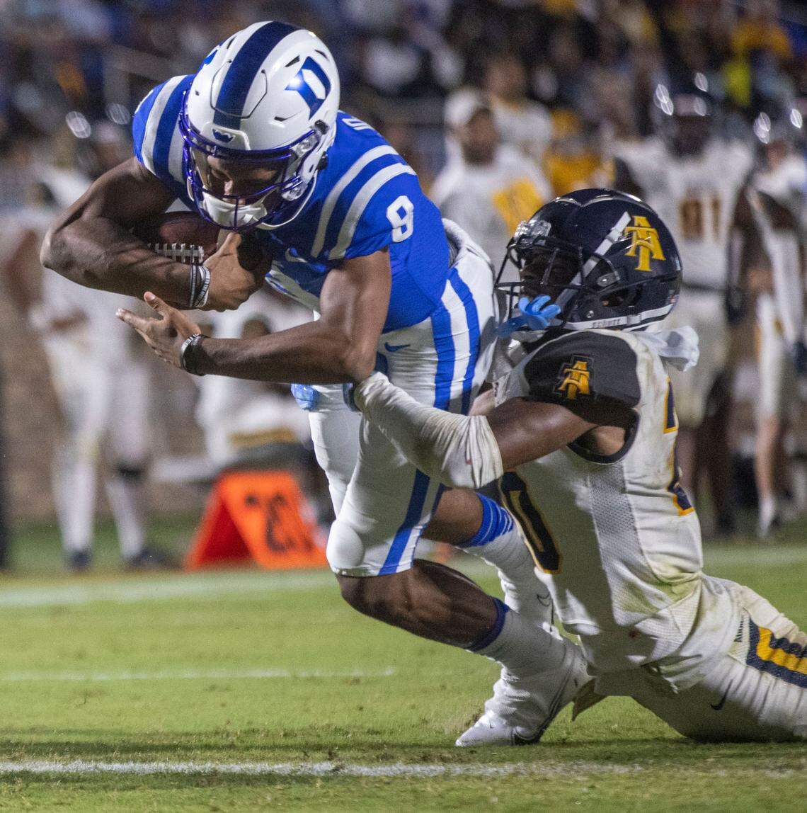 Duke’s Jordan Moore (8) scores a touchdown on a nine-yard carry against North Carolina A&T’s Najee Reams (20) to give the Blue Devils a 42-17 lead in the third quarter on Friday, September 10, 2021 at Wallace Wade Stadium in Durham, N.C.