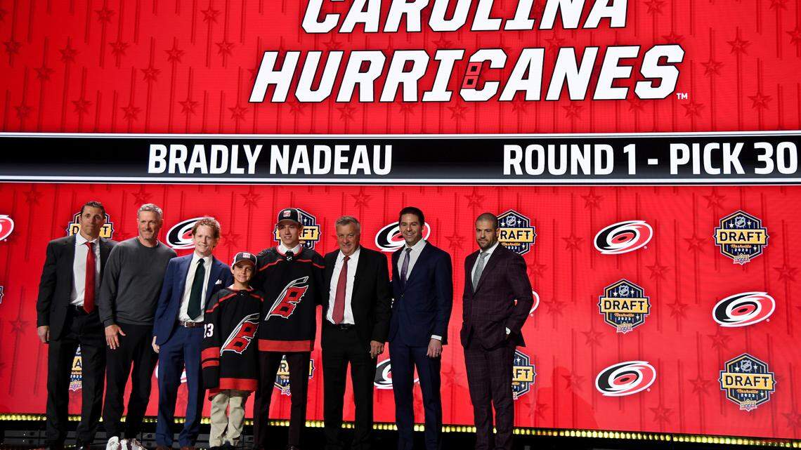 Jun 28, 2023; Nashville, Tennessee, USA; Carolina Hurricanes draft pick Bradly Nadeau stands with Hurricanes staff after being selected with the thirtieth pick in round one of the 2023 NHL Draft at Bridgestone Arena. Mandatory Credit: Christopher Hanewinckel-USA TODAY Sports