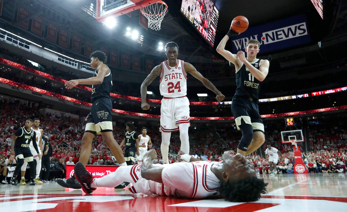 N.C. State’s Ernest Ross (24) celebrates with Jarkel Joiner (1) after Joiner made the basket while being fouled during N.C. State’s 90-74 victory over Wake Forest at PNC Arena in Raleigh, N.C., Wednesday, Feb. 22, 2023.