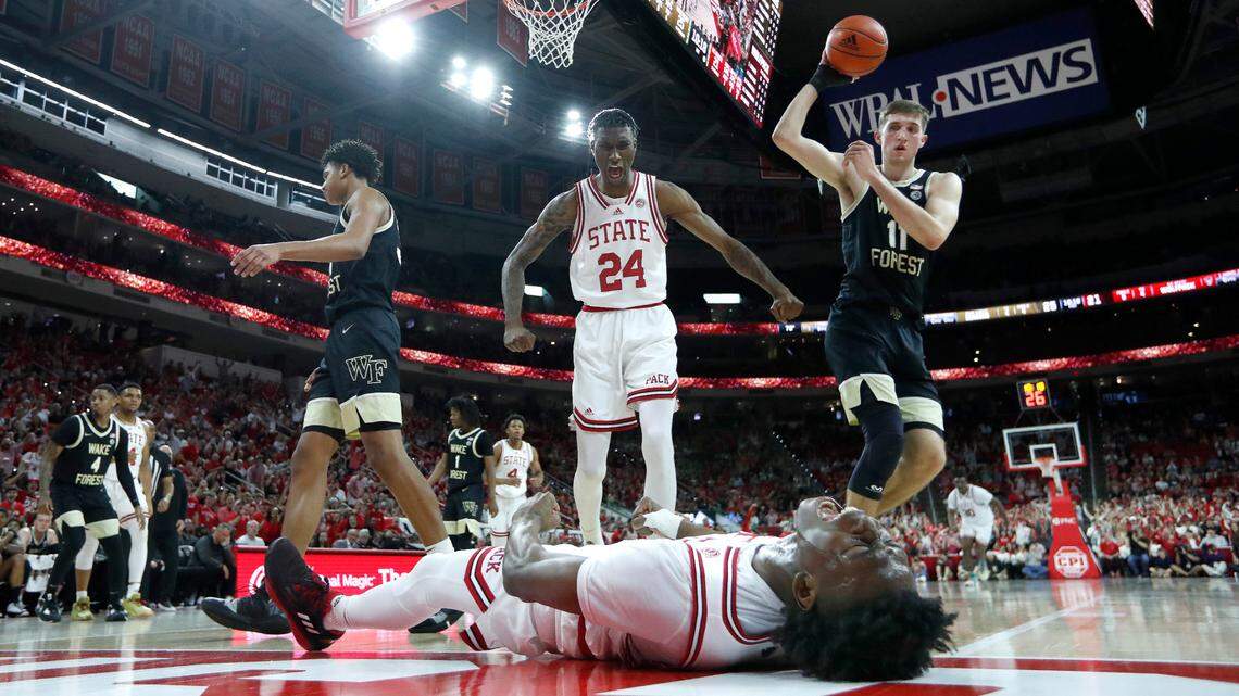 N.C. State’s Ernest Ross (24) celebrates with Jarkel Joiner (1) after Joiner made the basket while being fouled during N.C. State’s 90-74 victory over Wake Forest at PNC Arena in Raleigh, N.C., Wednesday, Feb. 22, 2023.