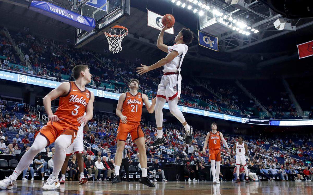 N.C. State’s Jack Clark (5) shoots as Virginia Tech’s Sean Pedulla (3) and Grant Basile (21) watch during N.C. State’s 97-77 victory over Virginia Tech in the second round of the ACC Men’s Basketball Tournament in Greensboro, N.C., Wednesday, March 8, 2023.