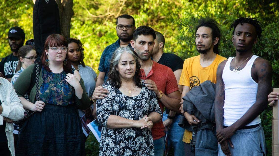 Siavash Mojarrad, the brother of Soheil Antonio Mojarrad, and their mother Judy Mojarrad, center, mourn for Soheil during a vigil at a shopping center off New Bern Avenue in Raleigh Tuesday, April 23, 2019. Soheil Mojarrad was killed in an officer-involved shooting Saturday.