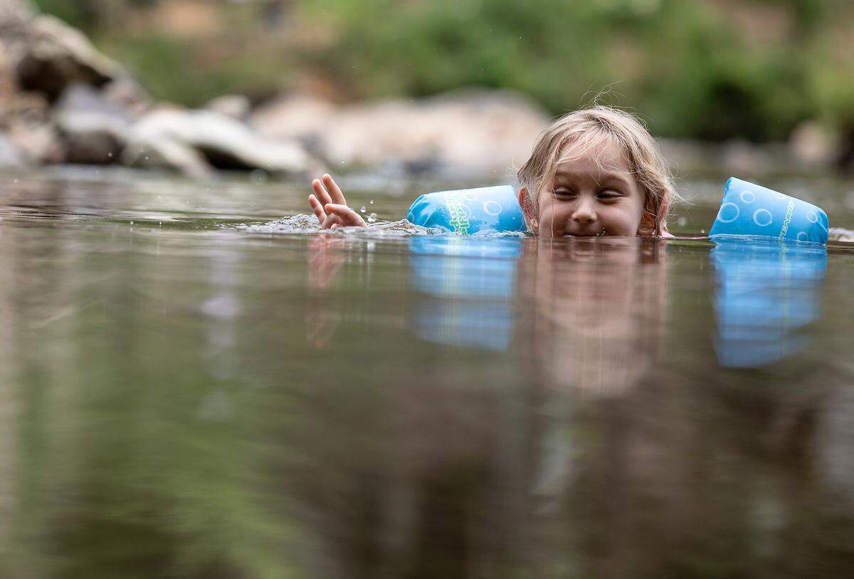 Fiona Campbell, 6, wades near the shore at Sennett’s Hole on the Eno River on Monday, July 3, 2023, in Durham, N.C.